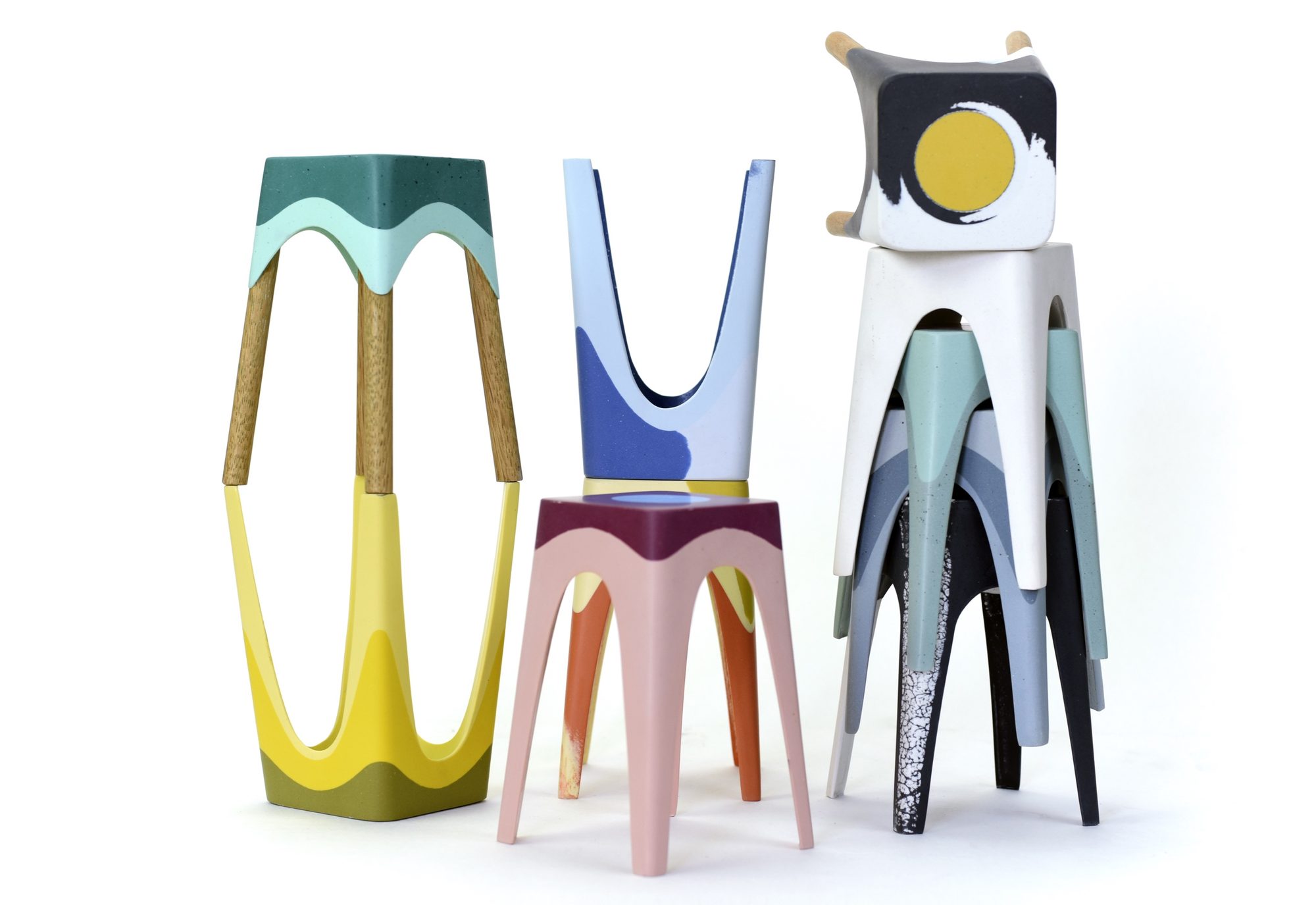 Hand-cast stools in colourful terrazzo and resin, some with oak legs, standing and stacked together, by Maor Aharon